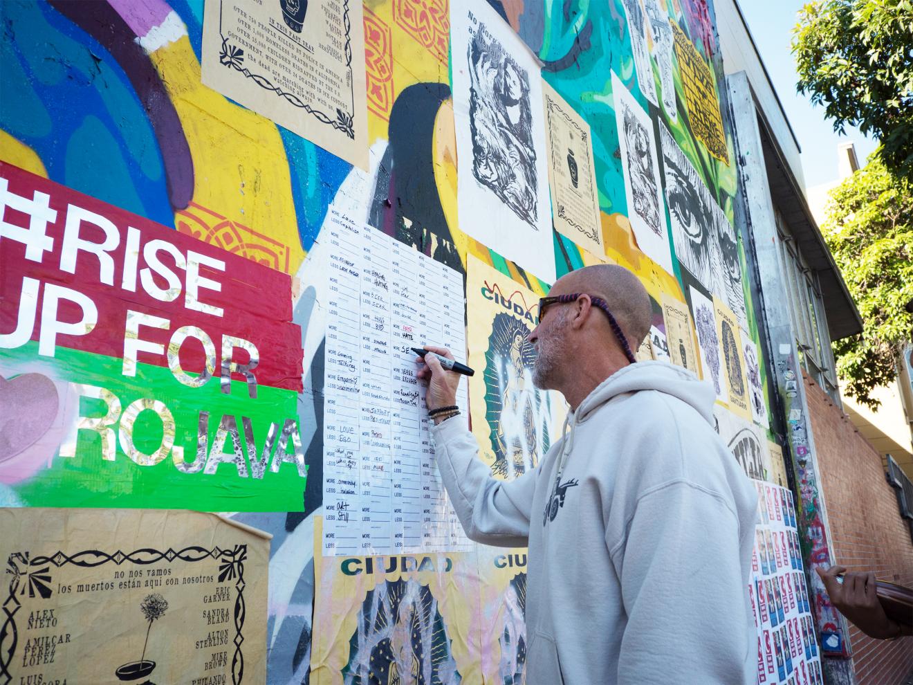 man drawing on a board