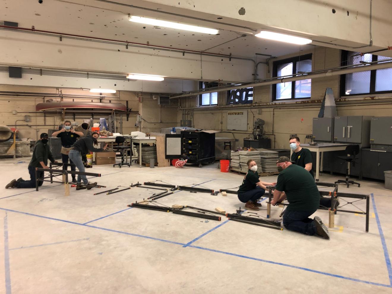 students assembling a steel bridge