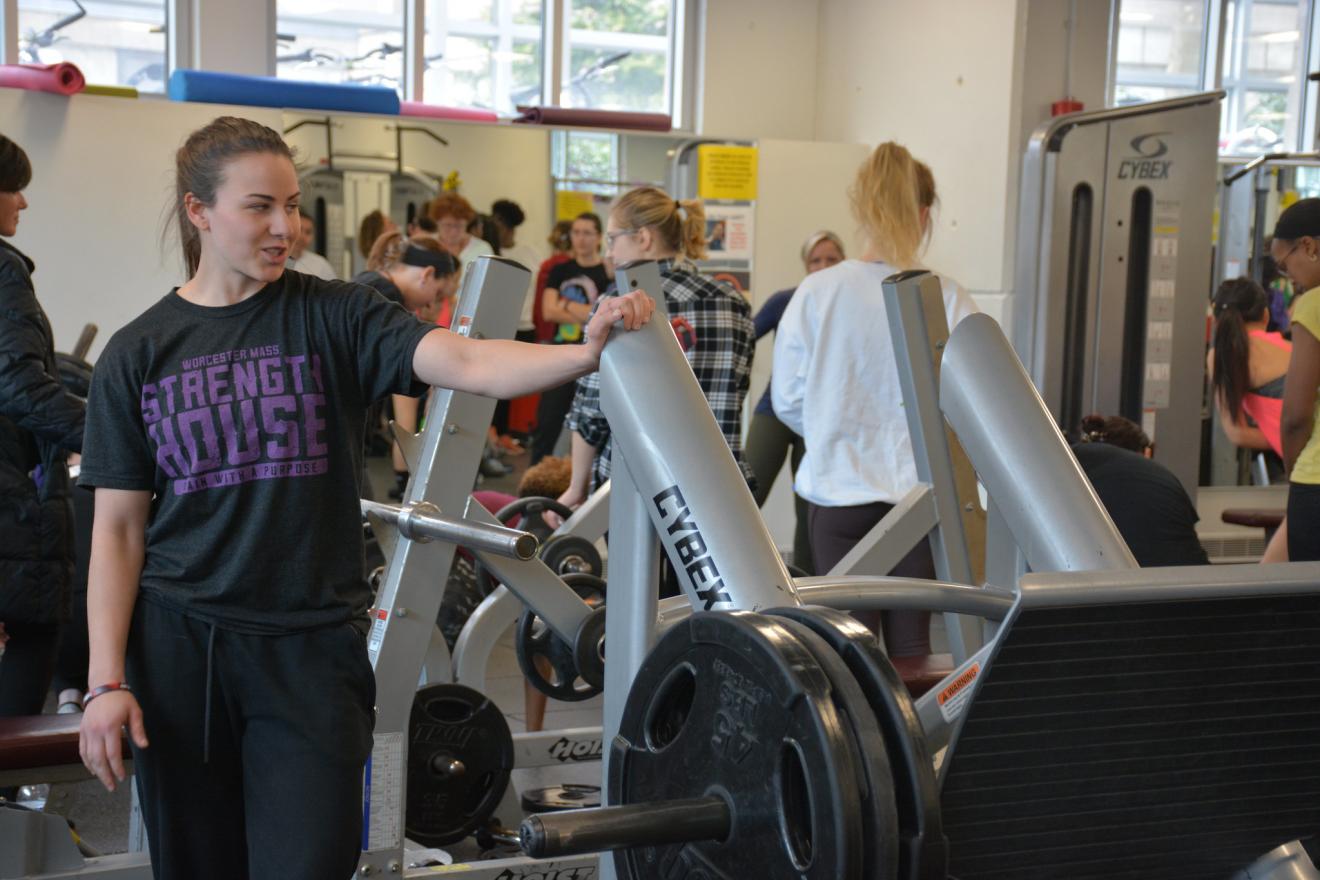 Fitness trainer showing off techniques to students