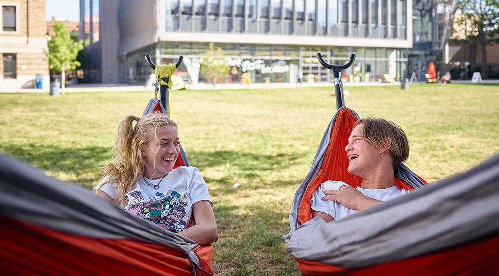 Two students in hammocks on the quad