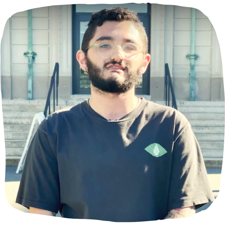 student standing in front of school building