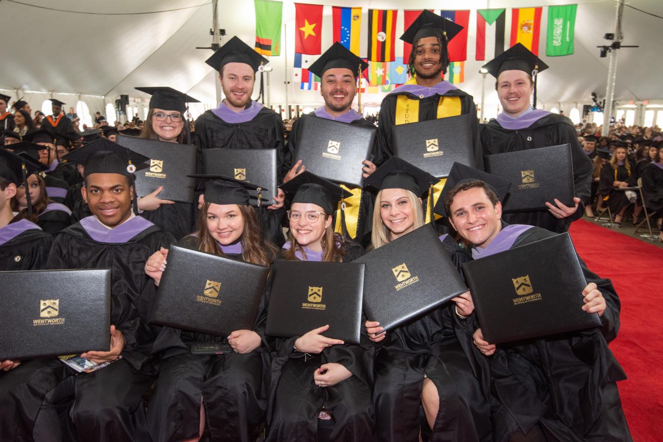 students posing in graduation robes