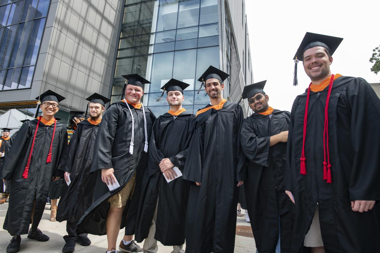 students lined up in front of a building