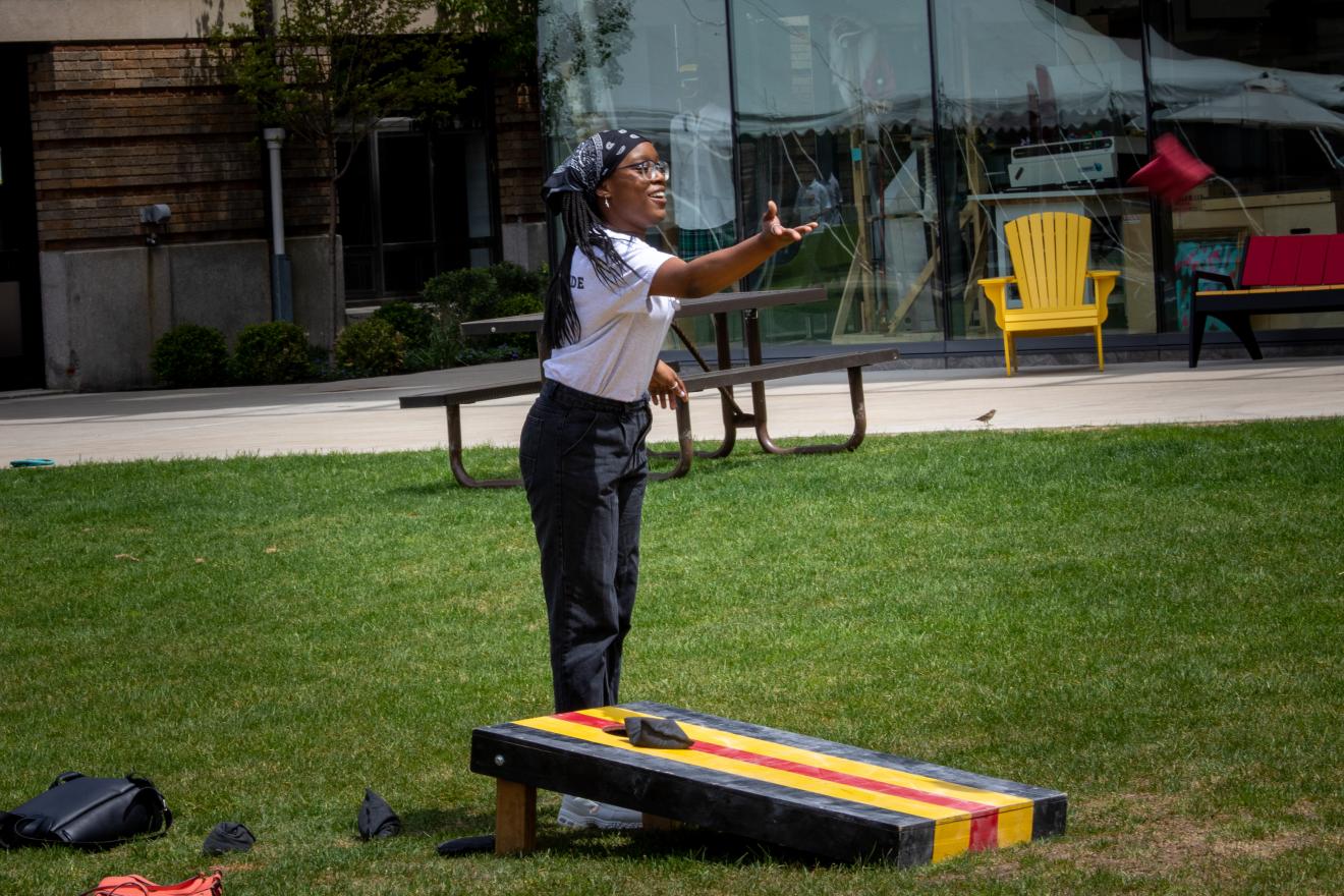 woman tossing a beanbag in a game