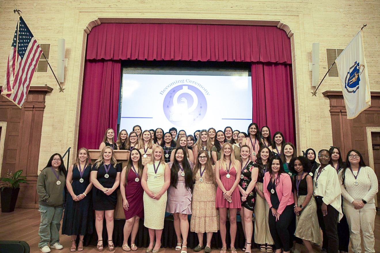 large group of women gathered on stage