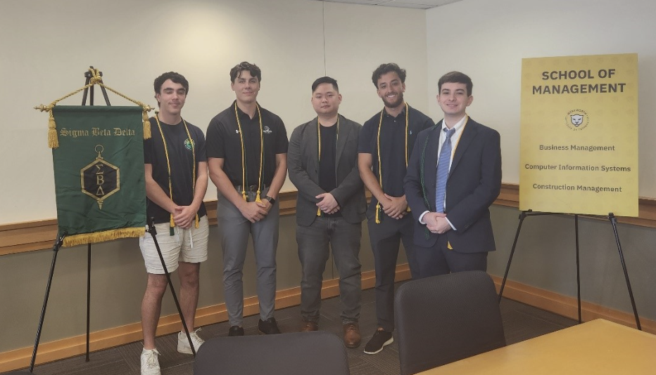 students standing together in front of a long table