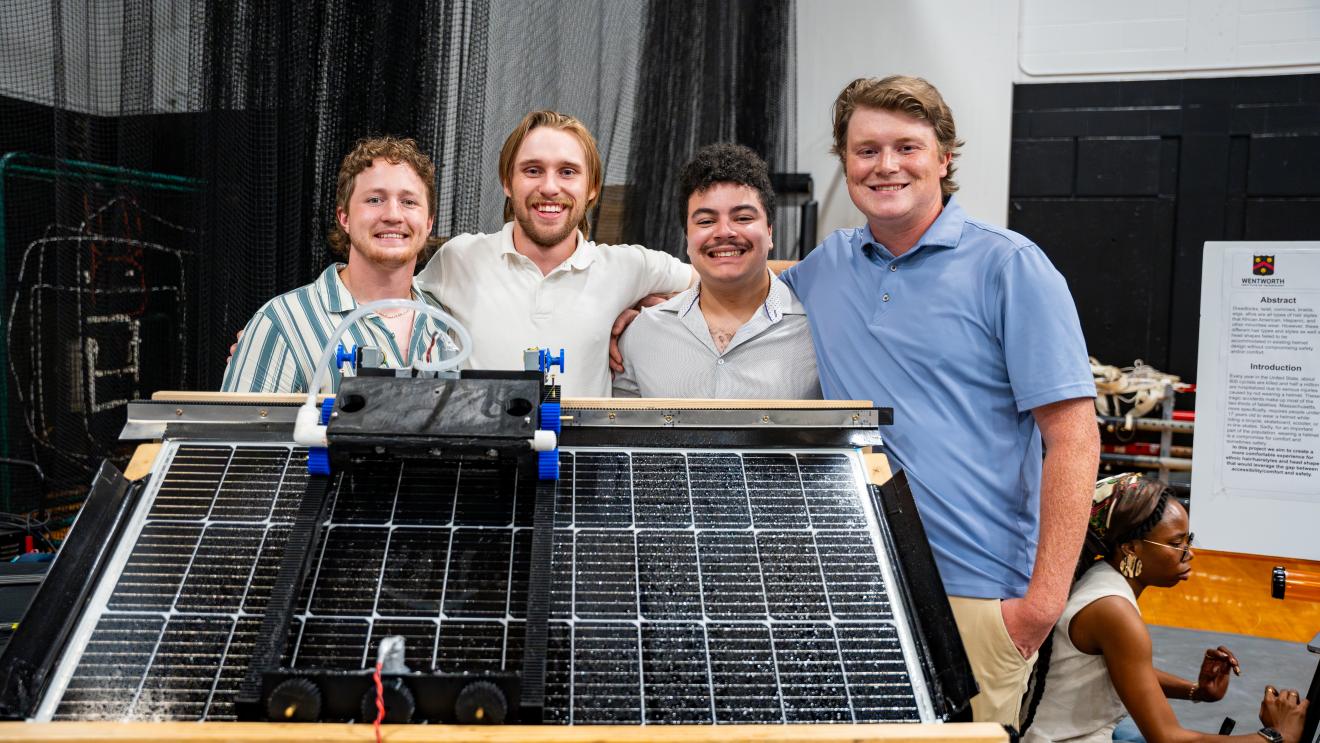 students stand behind a solar panel