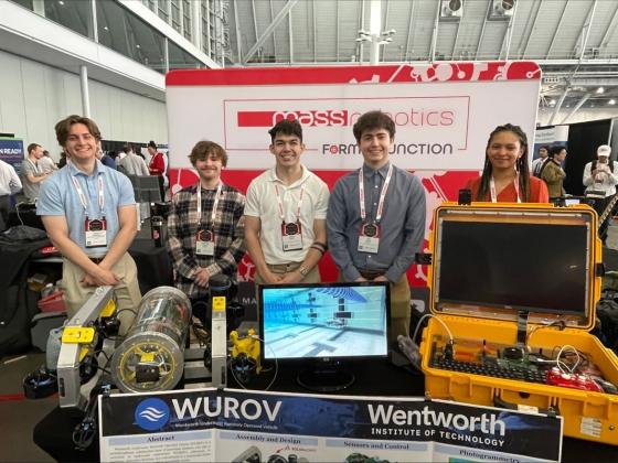 a team of students displaying an underwater robot