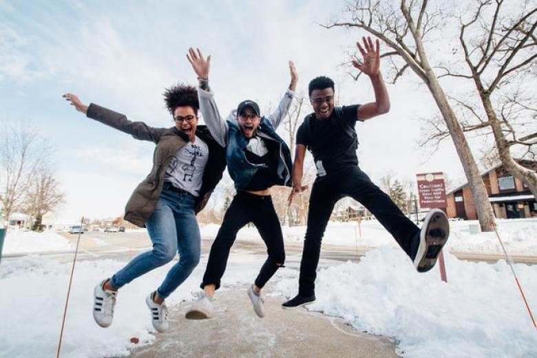 three students jumping in the air