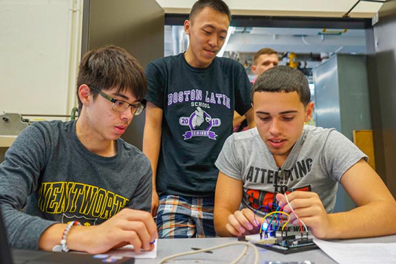 Three students working together on a project.