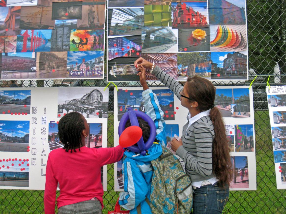 Student helping local youth engage in a community project.