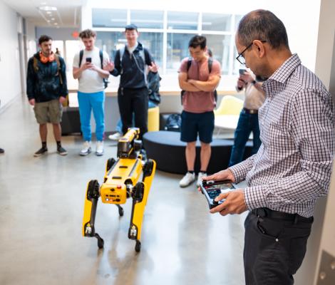 people operating a robotic dog