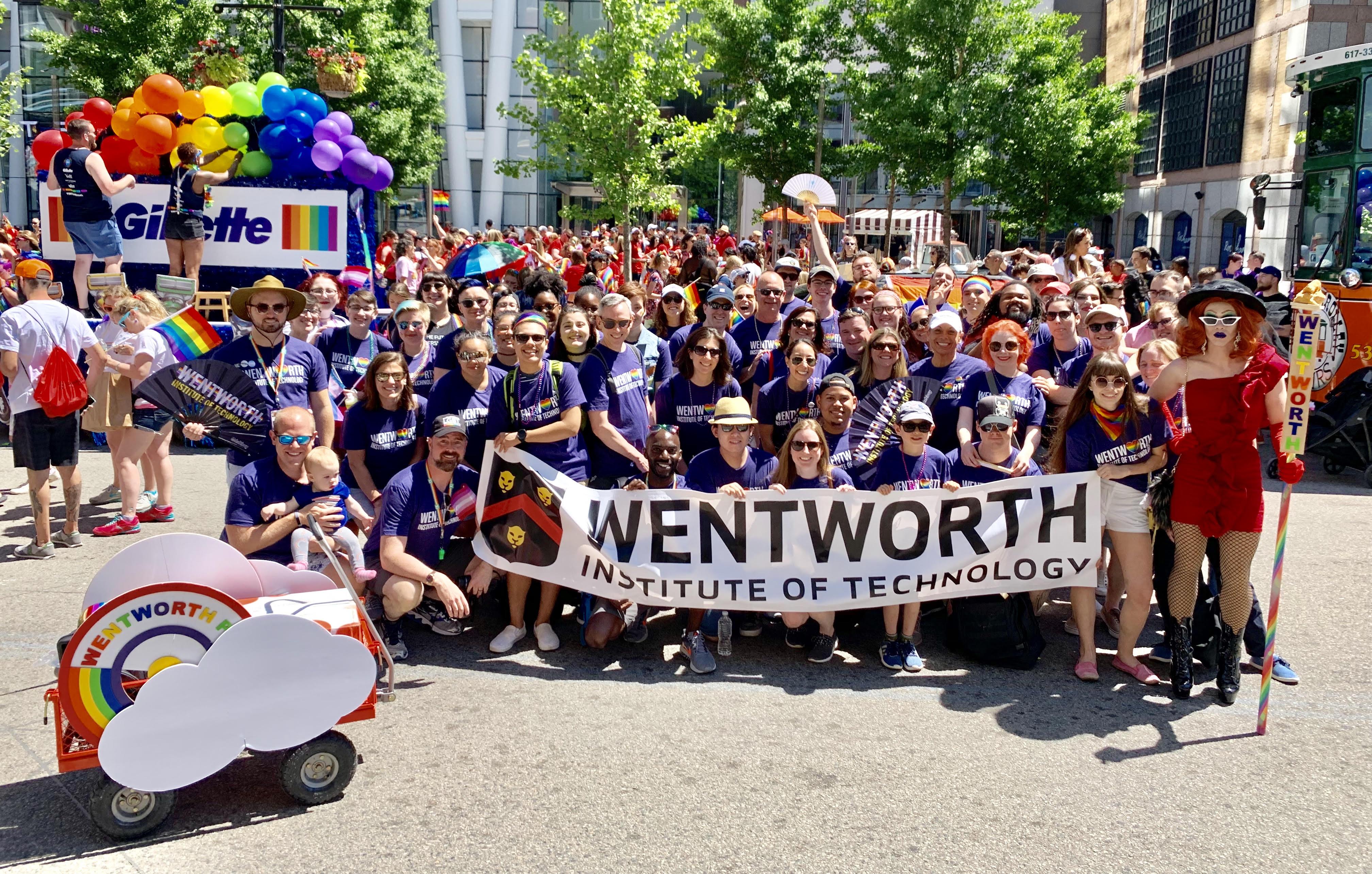 large group of people holding up a wentworth banner