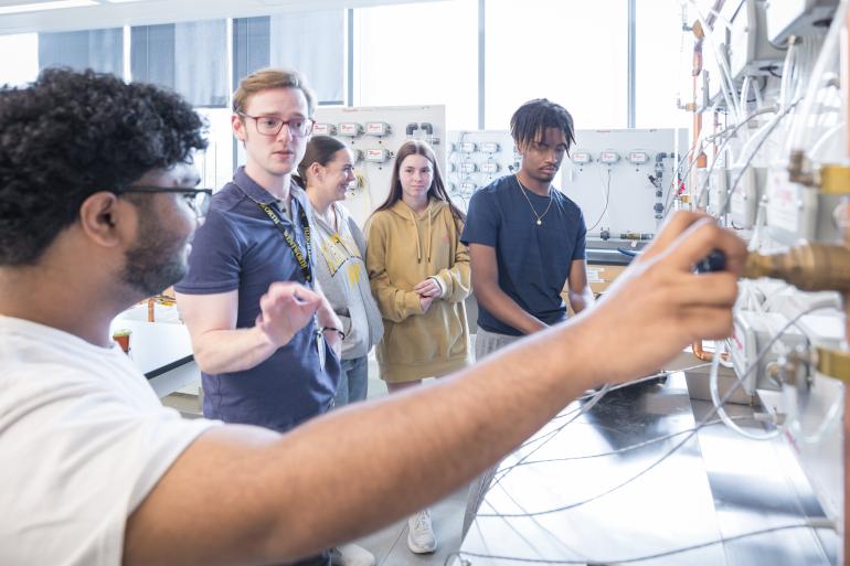 A group of students get a demo in the Civil Engineering Fluids Lab