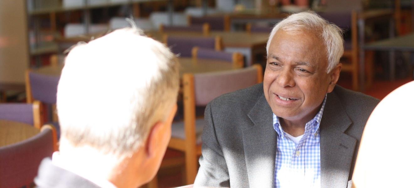  Professor Bhatti talks with colleagues. 