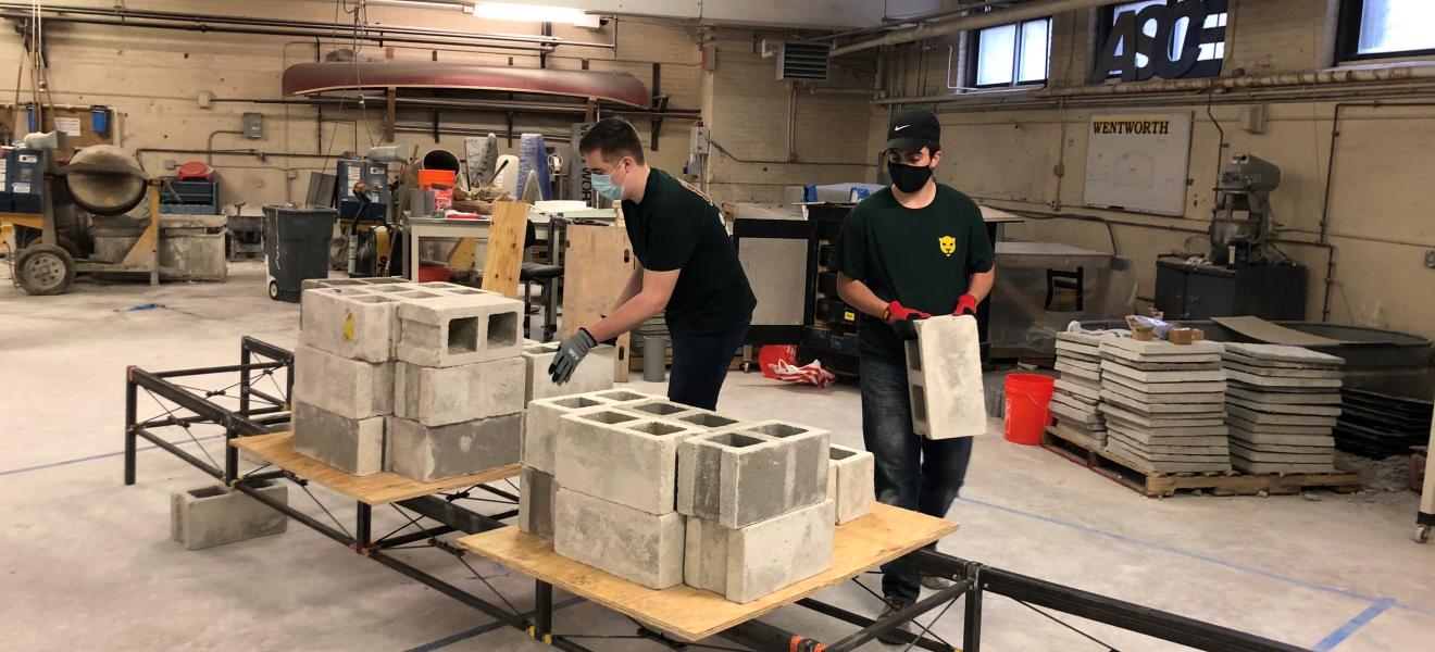 students assembling a bridge on concrete