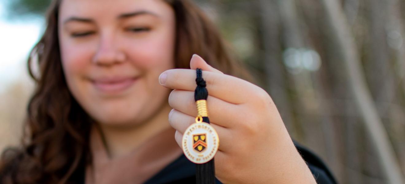 portrait of a woman holding a medallion 