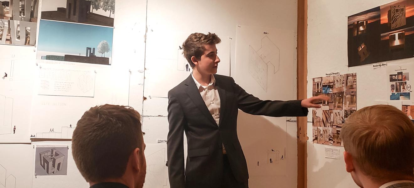 man presenting architectural work to audience