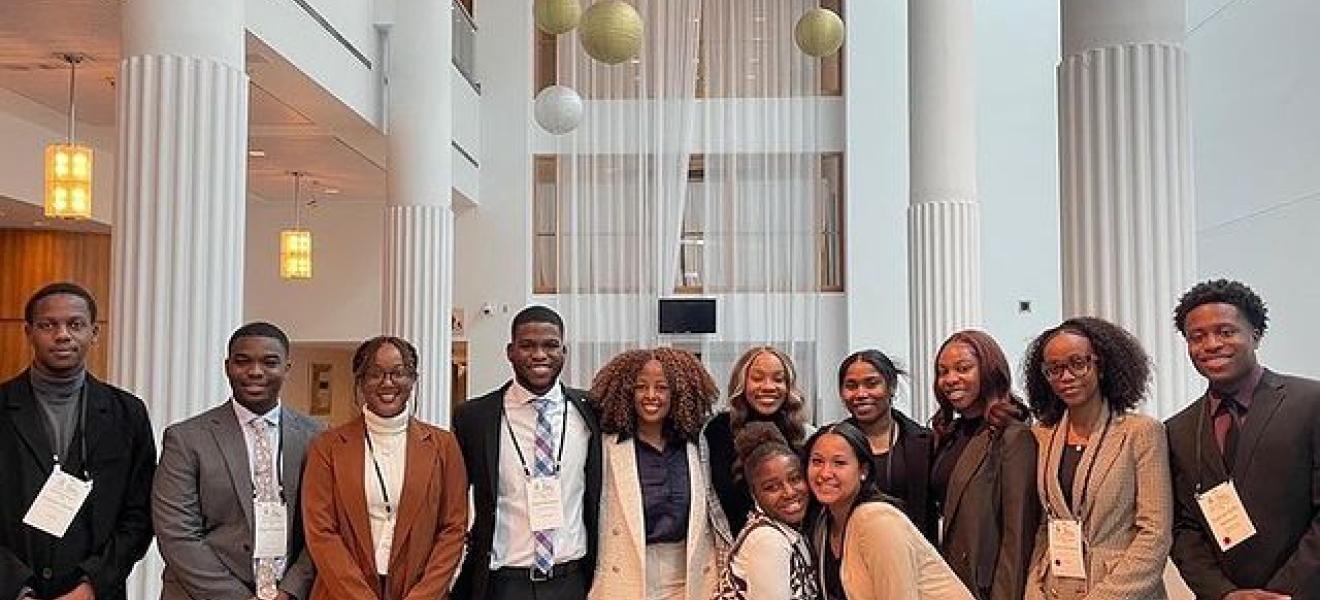 group of students pose in a large lobby