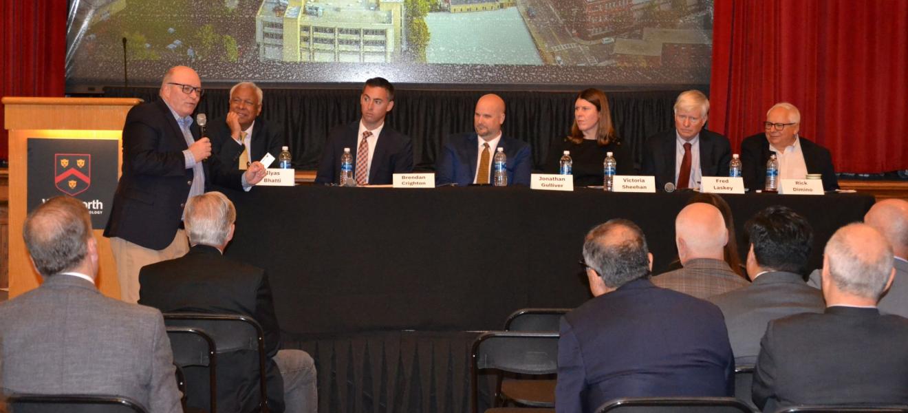 people sitting at a table as part of a panel