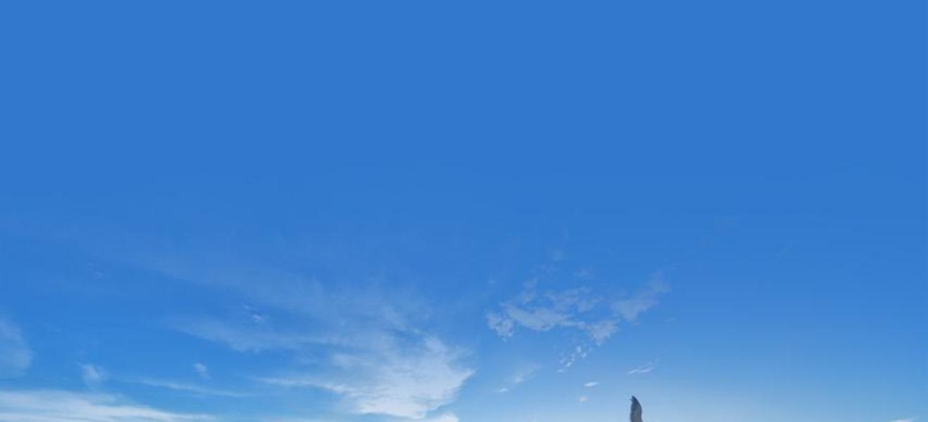 a beach with waves and blue sky