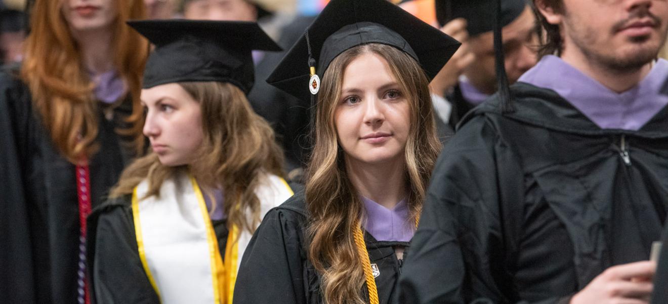 woman wearing a graduation robe and cap