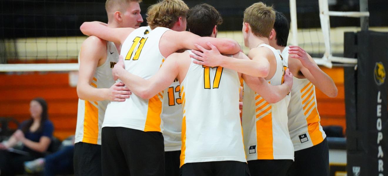 volleyball players huddle together