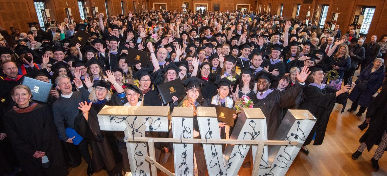 large group of people wearing graduation gowns